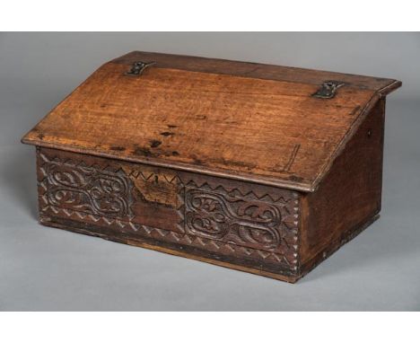 *Bible Box. An 18th century carved bible box,  with iron hinged fall, enclosing single shelf and vacant interior, the front p