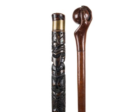 *Walking Stick. An early 20th century folk art wooden walking stick,  the knop carved as a hand clasping a ball, 89cm long, t