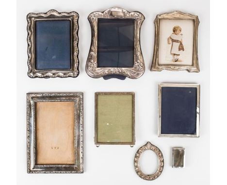 *Silver Frames. A collection of silver photograph frames,  including an Edwardian frame, Birmingham 1915, plain with reeded e