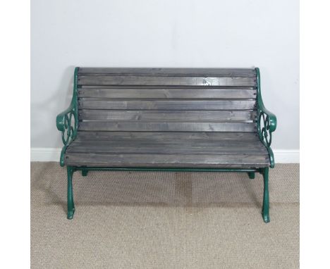 A green painted cast iron and slatted wood garden Bench, W 127 cm x H 78 cm x D 66 cm.