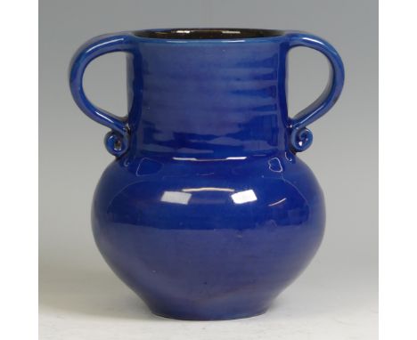 An Arts &amp; Crafts Liberty pottery twin-handled Vase,  in deep blue glaze, of globular body and cylindrical neck, twin scro