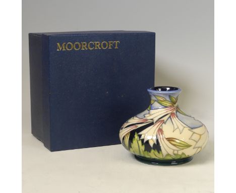 A Moorcroft pottery ‘Lily Come Home’ pattern squat vase, 2004, designed by Emma Bossons, 10.5cm high, with original box.