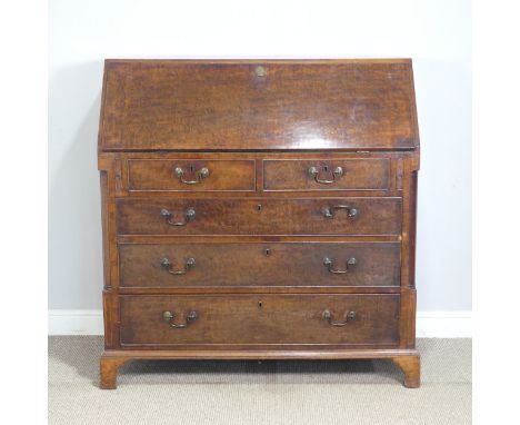 A Georgian figured mahogany Bureau, the sloped fall front enclosing a good fitted interior, above two short and three long be