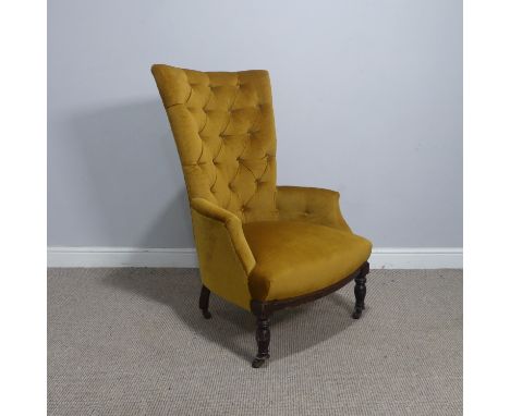An antique button-back upholstered yellow Armchair, raised on turned supports, W 64 cm x H 101 cm x D 67 cm.