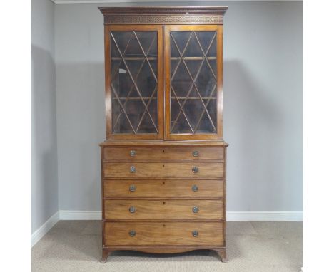 A Georgian mahogany secretaire Bookcase, the upper section with moulded cornice and fretwork applied frize, above astragal gl