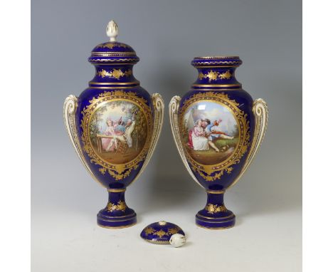 A pair of 19thC Sevres style 'Napoleon' blue Vases and Covers, twin-handled baluster form with cobalt blue ground and central