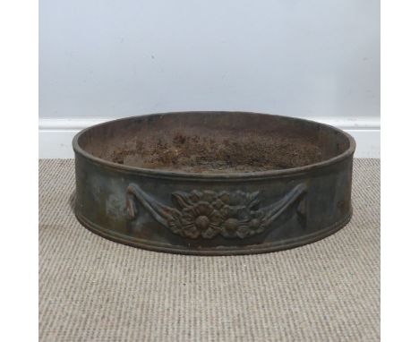 A large 20th century cast iron Planter, of a circular form embossed with floral motifs, W 60 cm x H 15 cm x D 60 cm.