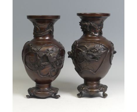 A pair of Japanese bronze Vases, Meiji Period (1868-1912), each cast in relief with a dragon and birds perched on branches, o
