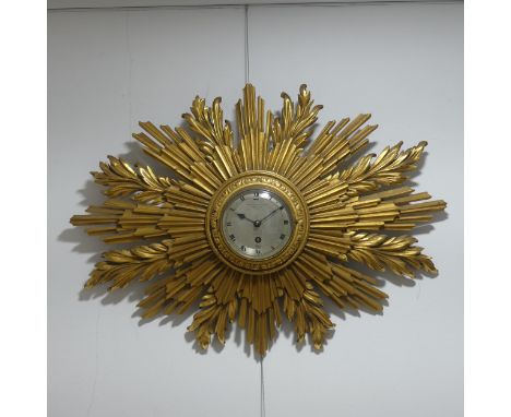 An early 20th century giltwood sunburst wall Clock, retailed by Goldsmiths &amp; Silversmiths Co Ltd, the 4 1/2 inch silvered