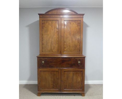 A George III mahogany secretaire Bookcase, decorated with shell inlay, the arched pediment over paneled doors enclosing a adj