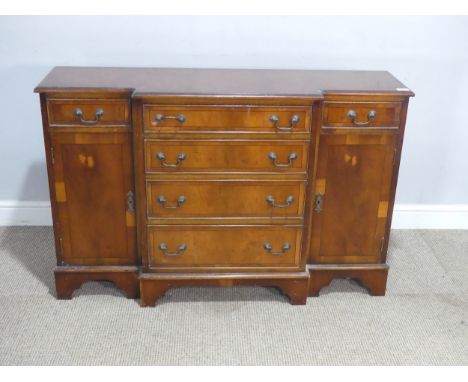 A reproduction mahogany breakfront Sideboard, of small proportions, with an arrangement of six drawers and two cupboard doors