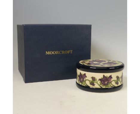 A Moorcroft pottery limited edition ‘Pulsatilla’ pattern round lidded hat box, 2010, by Vicky Lovatt, no.49/100, painted and 