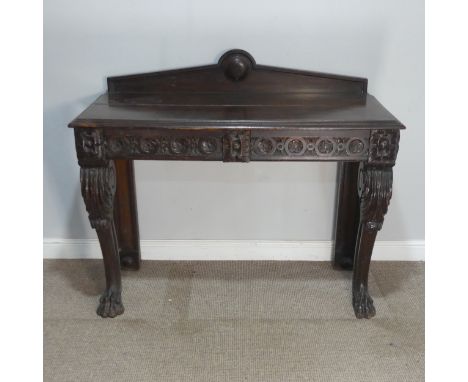 A Victorian carved oak console Table, the moulded rectangular top with shaped gallery, above two short frieze drawers and rai