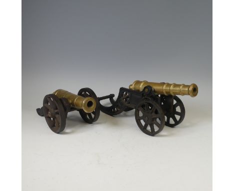 A large late 19th century decorative brass signal Cannon, with cast iron base, W 17 cm x H 14 cm x D 34 cm, together with ano