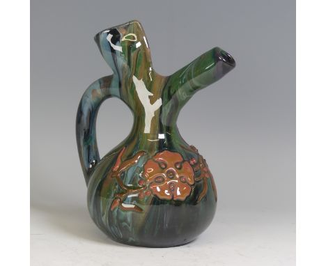Sir Edmund Elton for Sunflower Pottery; a spouted Ewer, decorated in trickles of greens, blues and ochres, with floral decora