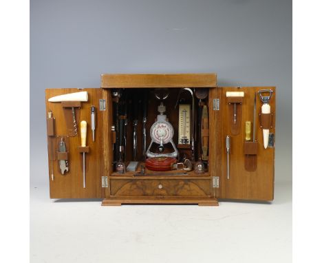 An early 20th century figured walnut table-top cabinetmaker's tool Box and Tools, retailed by Asprey, the hinged top and two 