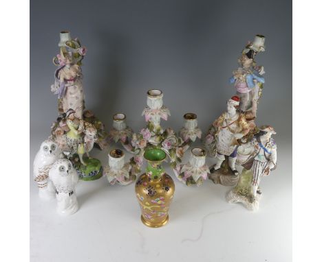 A pair of Sitzendorf porcelain figural Candlesticks, depicting two young figures amongst floral relief, H 29cm marks to base,