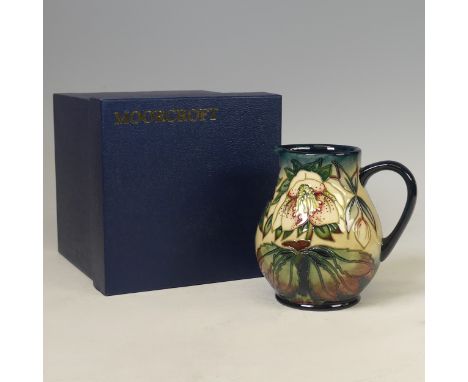 A Moorcroft pottery 'Hellebore' pattern jug, circa 1999, designed by Nicola Staney, painted marks, 15cm high, with original b