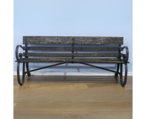 An early 20th century wrought iron and wooden slat garden Bench, W 182 cm x H 77 cm x D 67 cm.