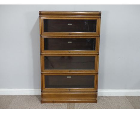 An early 20th century Globe Wernicke light oak four sectional Bookcase, with glazed sliding doors and bearing Globe Wernicke 