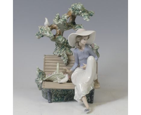 A boxed Lladro Figure Sunday in the Park, modelled as a woman sat on a bench under a tree, sculpted by Antonio Ramos, no 5365
