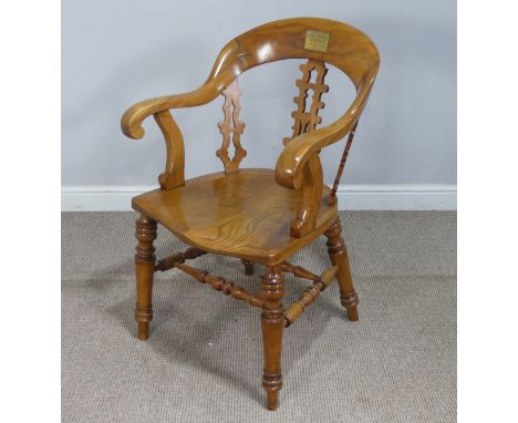 A 19th century beech and elm smokers bow/desk Armchair, the rounded back inset with brass plaque ''Buddugolyn Eisteddfod, Tab