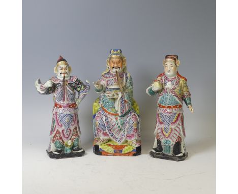 A trio of Chinese porcelain figures of Elders, to comprise a seated figure holding a book, damage to hand, with beard, H 33.5