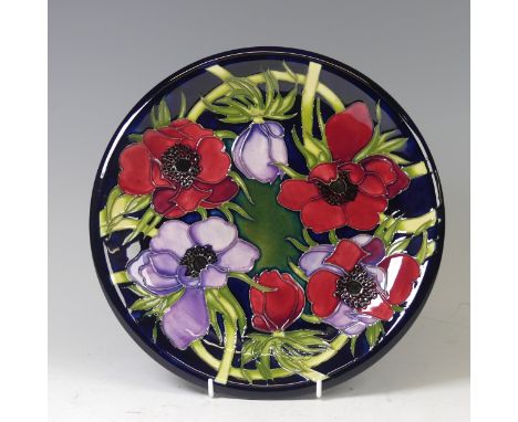A Moorcroft pottery ‘Anemone Tribute’ pattern circular plate, 2002, designed by Emma Bossons, impressed and painted marks, be