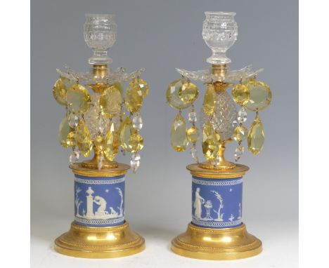 A pair of Victorian gilt metal and blue jasperware Candlesticks, each with cut glass pear shaped drops and raised on drum bas