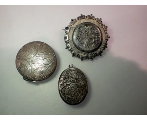 Victorian silver mourning brooch, silver locket and a silver pill box containing a faceted garnet. UK P&amp;P Group 1 (£16+VA