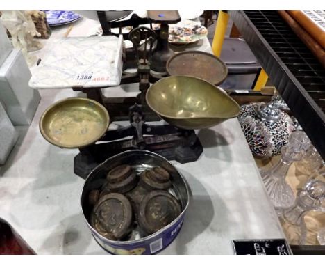 Two cast iron weighing scales, including a tin of weights. Not available for in-house P&amp;P