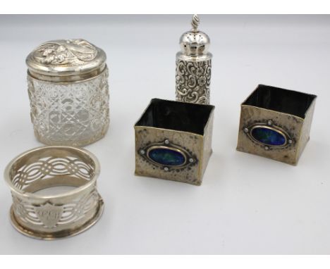 A small selection of silver comprising; a late Victorian silver pepperette, with elaborate floral / foliate design and twiste