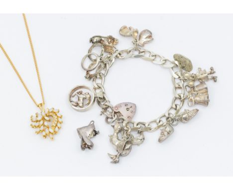 A silver vintage charm bracelet, comprising a flat curb bracelet with padlock clasp, suspending various silver and white meta