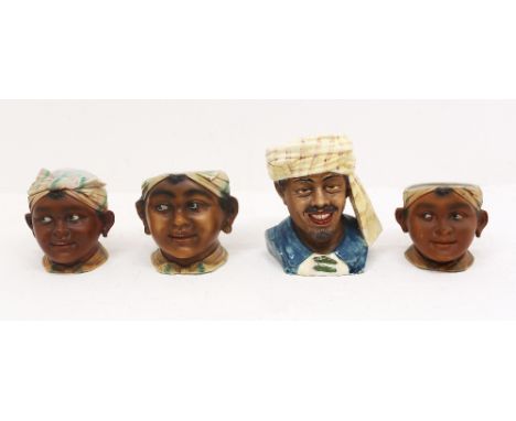 A set of three novelty 20th century tobacco jars, all of a young boy wearing head scarf (two missing covers), together with a