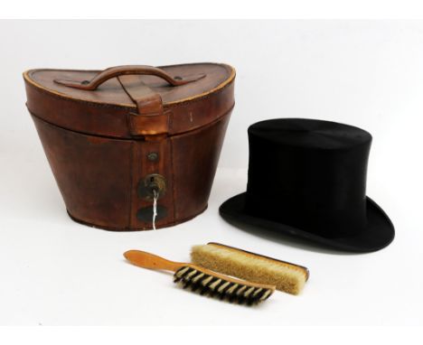 An early 20th Century black top hat by Henry Heath Limited, in original lockable box with brushes, 17cm x 20.5cm.