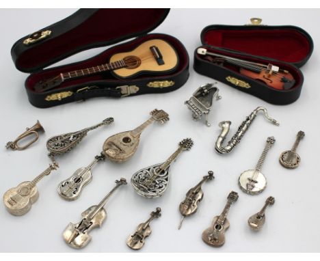 A collection of mixed late 20th century or Modern novelty silver or white metal miniature music instruments comprising of vio