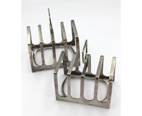 A pair of George V silver four division toast racks, with angular handles, hallmarked by Harrison Bros & Howson, Sheffield, 1