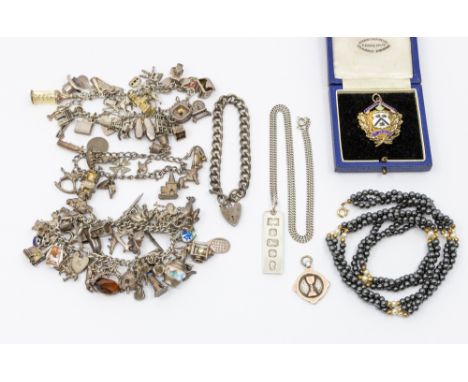 A collection of costume jewellery to include three vintage silver charm bracelets, suspending various silver and white metal 