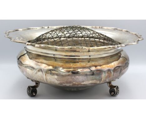A large George V silver rose bowl, of jardinière shape with scrolled rim and upon three elaborate scrolled feet, hallmarked b