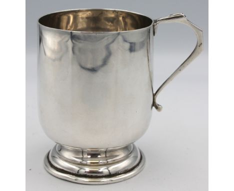 A George VI silver mug, of circular shape upon a circular foot with angular handle, hallmarked by Charles S Green, Birmingham