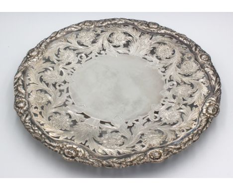 An Elizabeth II silver platter, elaborately decorated with pierced and engraved foliage and flowers, with cast matching borde