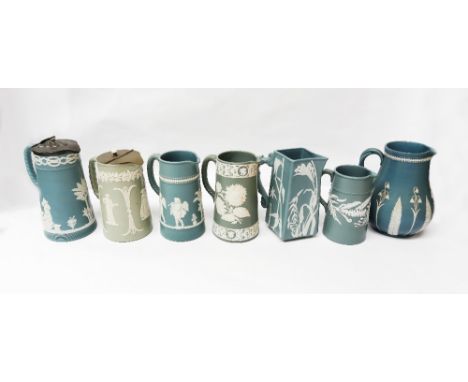 A collection of mixed Dudson light green ground jugs, all unmarked but with other base marks and varying white relief designs