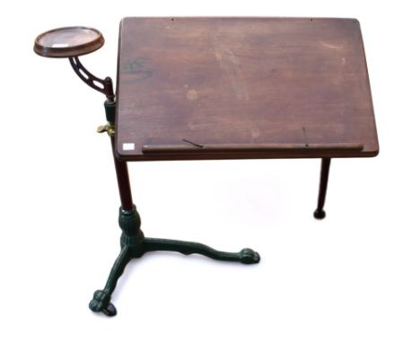 A Victorian reading tray and wine stand, on cast iron tripod, paw feet complete with castors, having telescopic shaft and wit