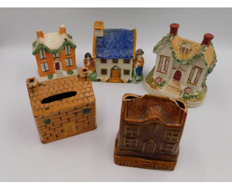 Five early to mid 19th Century ceramic/stoneware money boxes in the style of houses including a Pratt ware money box, some wi