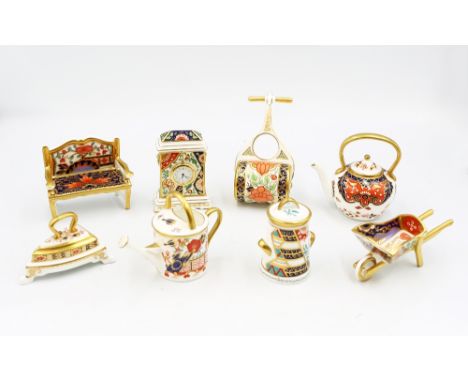 A collection of Royal Crown Derby trinkets of various shapes all in Imari type patterns and colours , to include a Clock , Wa