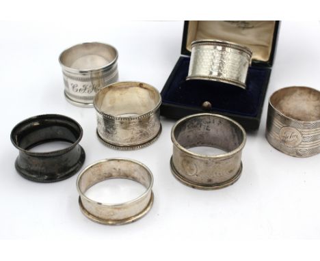 A collection of mixed silver napkin rings comprising: a Chester silver example with engine turned decoration by Turner & Simp