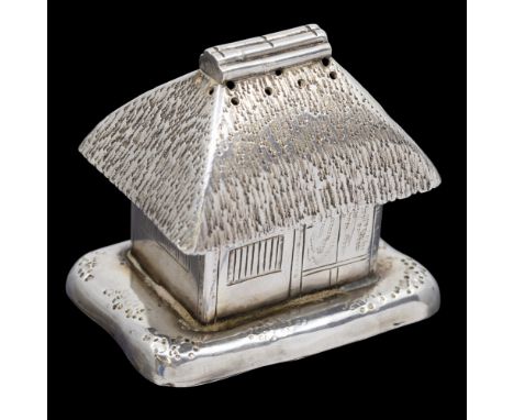 An early 20th Century Japanese silver novelty pepper pot modelled as a thatched hut with planished and engraved decoration, s