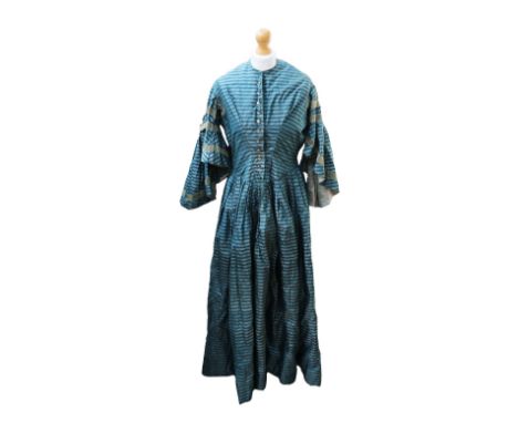 A silk Victorian striped dress from the 1860s, bottle green with a paler green background, the bodice has eleven glass button