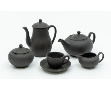 A Wedgwood miniature black basalt tea set consisting of coffee, tea pot, sugar bowl, milk jug and cup and saucer (no tray). (