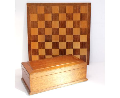 A contemporary chess board with boxed metal chess pieces in mahogany.